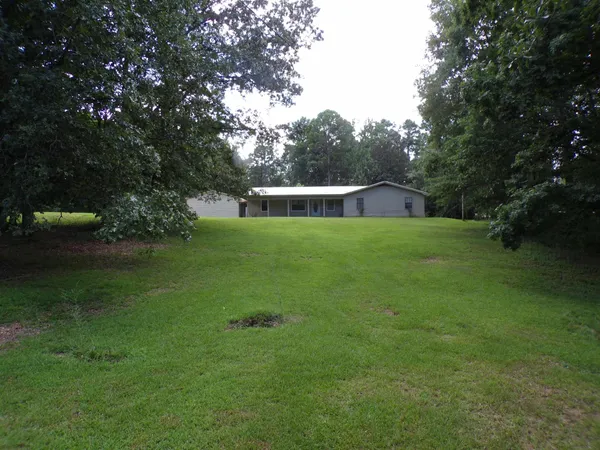 a view of a house with a backyard