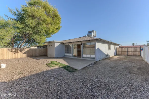 a view of a house with a backyard