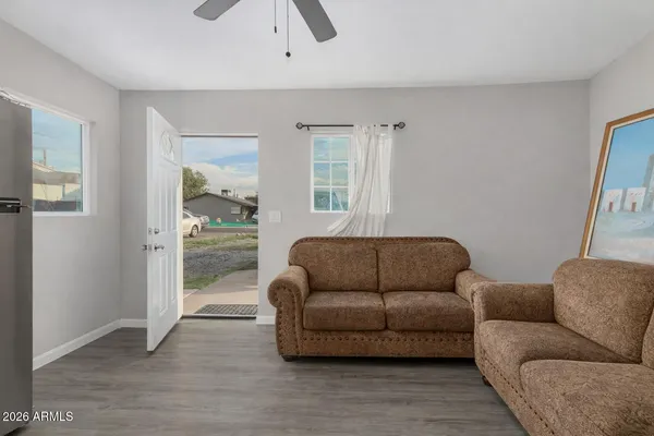a living room with furniture and a wooden floor