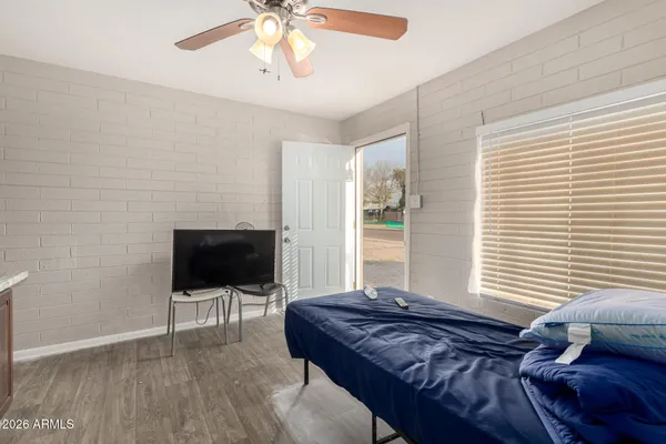 a bedroom with a bed and wooden floor