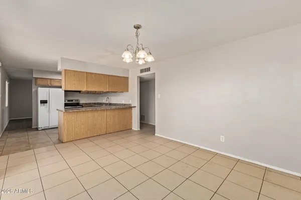 a large white kitchen with a stove a sink dishwasher and white cabinets with wooden floor