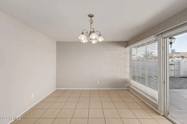 a large white kitchen with a stove a sink dishwasher and white cabinets with wooden floor
