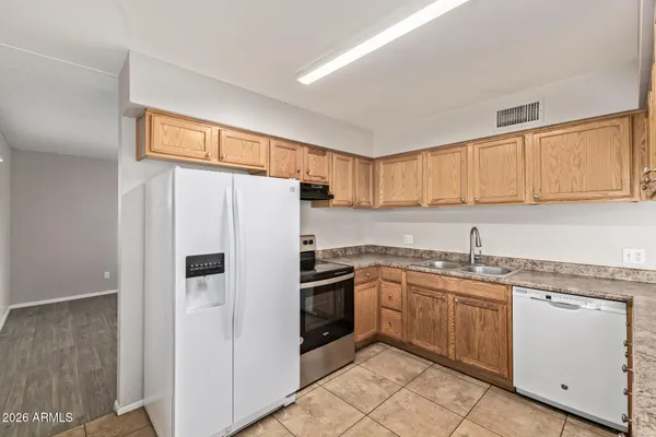 a kitchen with stainless steel appliances granite countertop refrigerator sink and cabinets