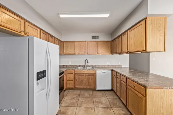 a kitchen with stainless steel appliances granite countertop a refrigerator sink and cabinets