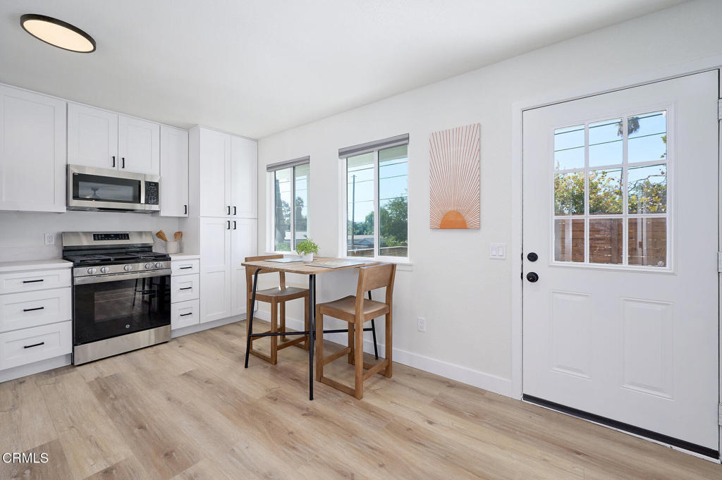 97 Everett Street, Unit B Moorpark, CA 93021 - Photo 14 of 28 a kitchen with a wooden floor and white appliances