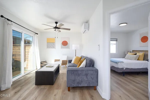 a living room with furniture and wooden floor