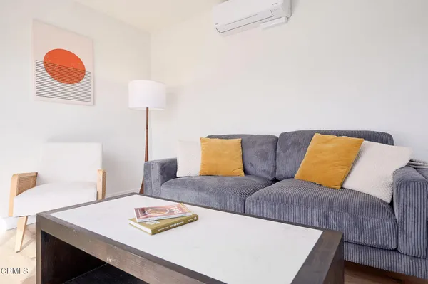 a living room with furniture and a lamp