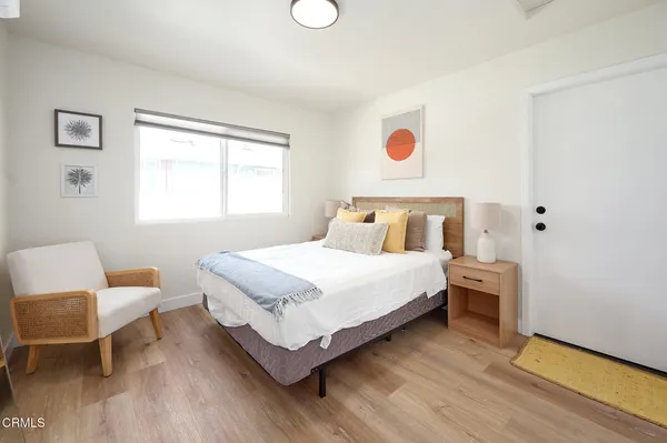 a bedroom with a bed and a chair