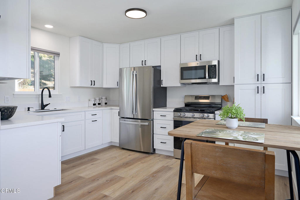 97 Everett Street, Unit B Moorpark, CA 93021 - Photo 4 of 28 a kitchen with refrigerator a stove a sink cabinets and wooden floor