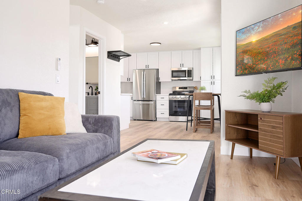 97 Everett Street, Unit B Moorpark, CA 93021 - Photo 7 of 28 a living room with stainless steel appliances furniture and a flat screen tv