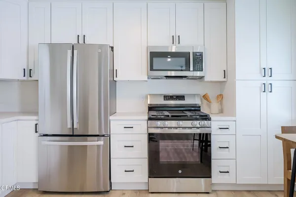 a kitchen with a stove and a refrigerator