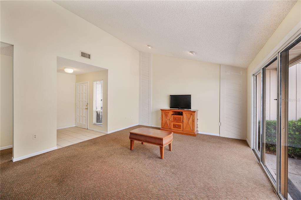 4231 Oak Loop, Unit 51 Mulberry, FL 33860 - Photo 10 of 29 a living room with furniture and a flat screen tv