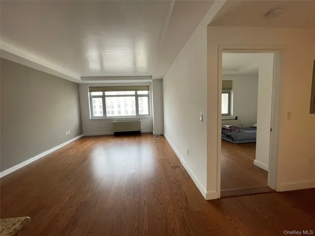 wooden floor in a room next to a window