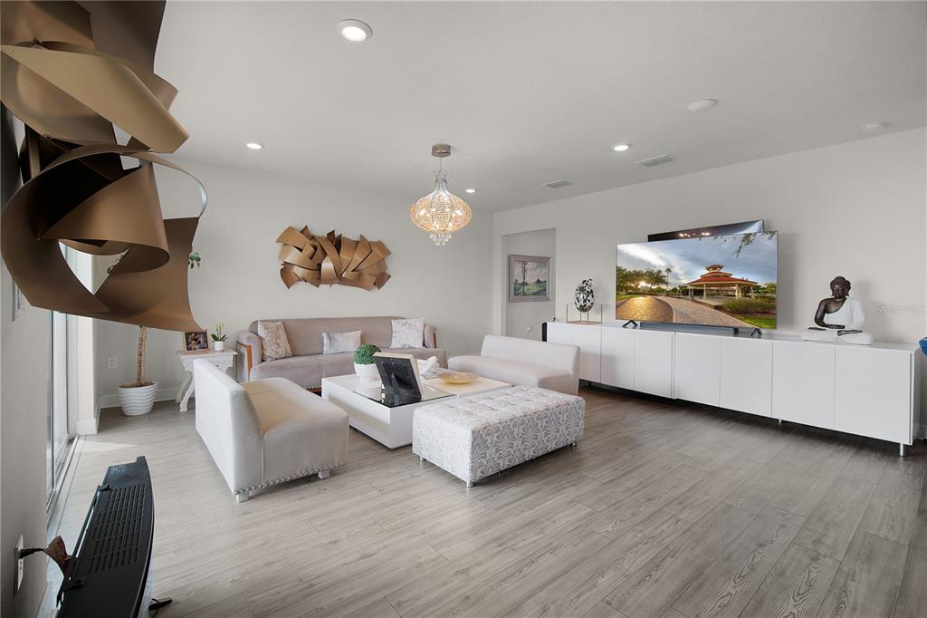 7379 Catania Loop Clermont, FL 34714 - Photo 11 of 37 a living room with furniture and a wooden floor