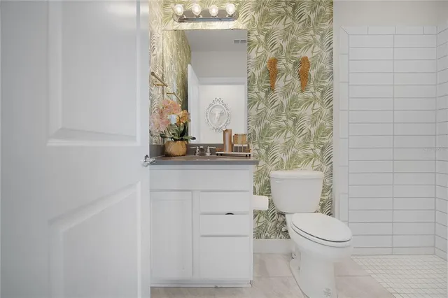 a bathroom with a toilet a sink and a mirror