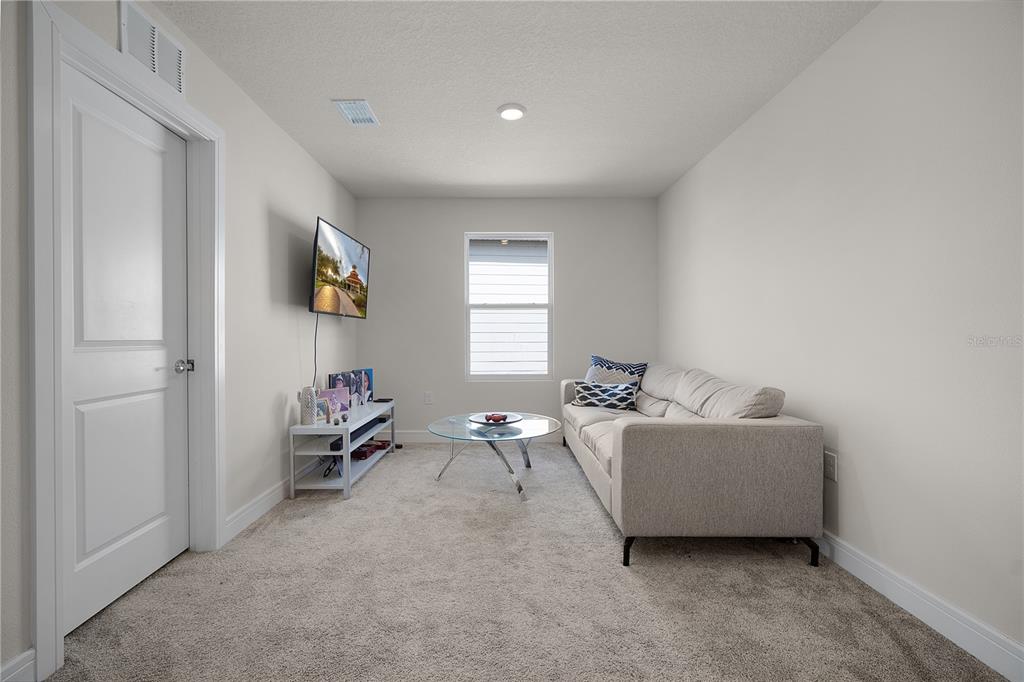 7379 Catania Loop Clermont, FL 34714 - Photo 16 of 37 a living room with furniture and a window