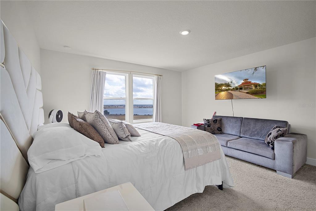 7379 Catania Loop Clermont, FL 34714 - Photo 17 of 37 a bedroom with a bed and a couch