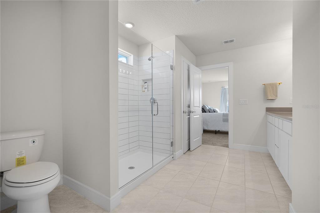 7379 Catania Loop Clermont, FL 34714 - Photo 19 of 37 a bathroom with a sink toilet and shower