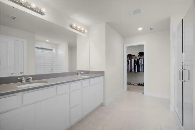 a bathroom with a double vanity sink and a mirror