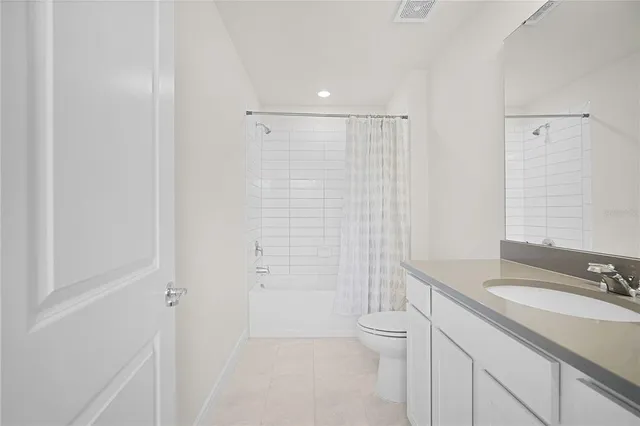 a bedroom with a bed and a night stand