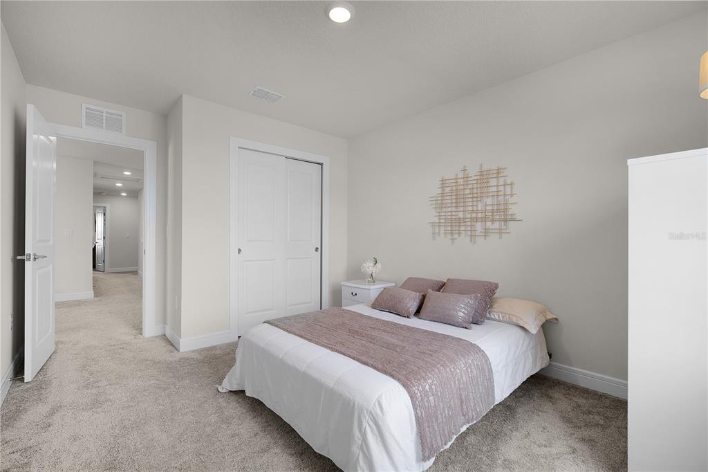 7379 Catania Loop Clermont, FL 34714 - Photo 25 of 37 a bedroom with a bed and a night stand