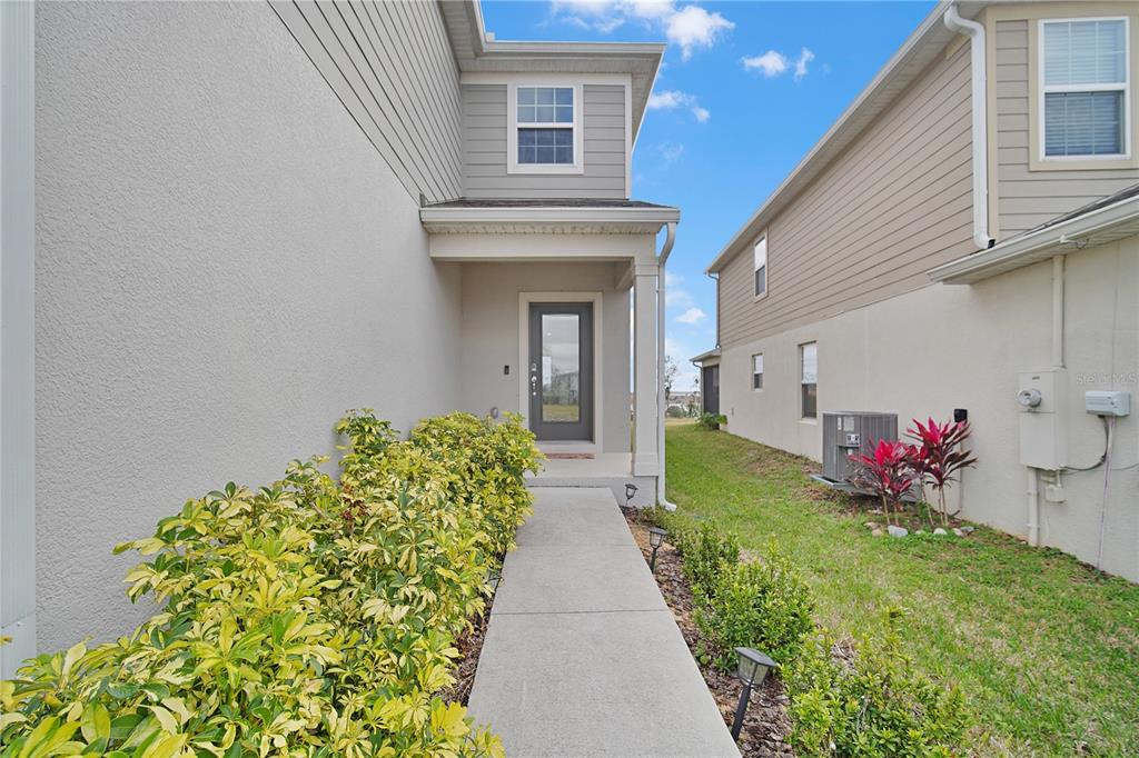 7379 Catania Loop Clermont, FL 34714 - Photo 4 of 37 a view of a house with a flower garden