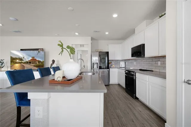 a kitchen with a stove a sink and a refrigerator