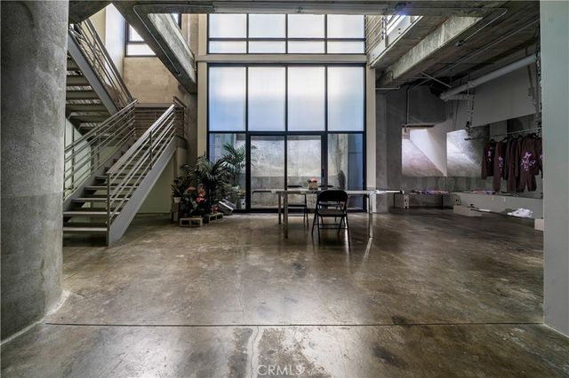 a view of a room with wooden floor and windows