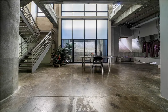 a view of a room with wooden floor and windows