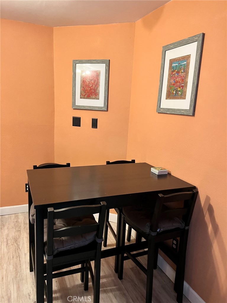 1723 Cedar Avenue, Unit 102 Long Beach, CA 90813 - Photo 11 of 22 a view of a dining room with furniture and wooden floor
