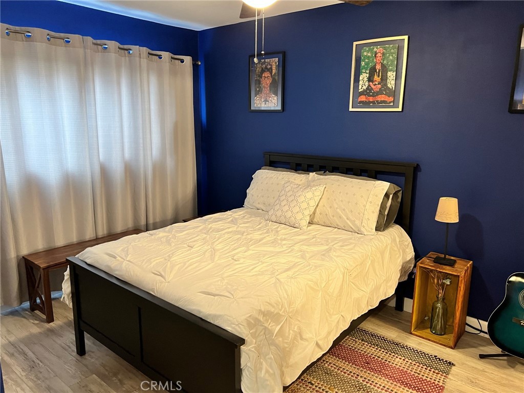 1723 Cedar Avenue, Unit 102 Long Beach, CA 90813 - Photo 16 of 22 a large bed sitting in a bedroom next to a curtain and a curtain
