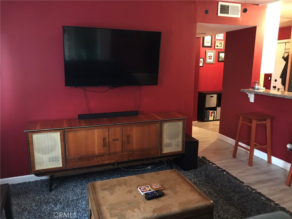 1723 Cedar Avenue, Unit 102 Long Beach, CA 90813 - Photo 6 of 22 a living room with furniture and a flat screen tv