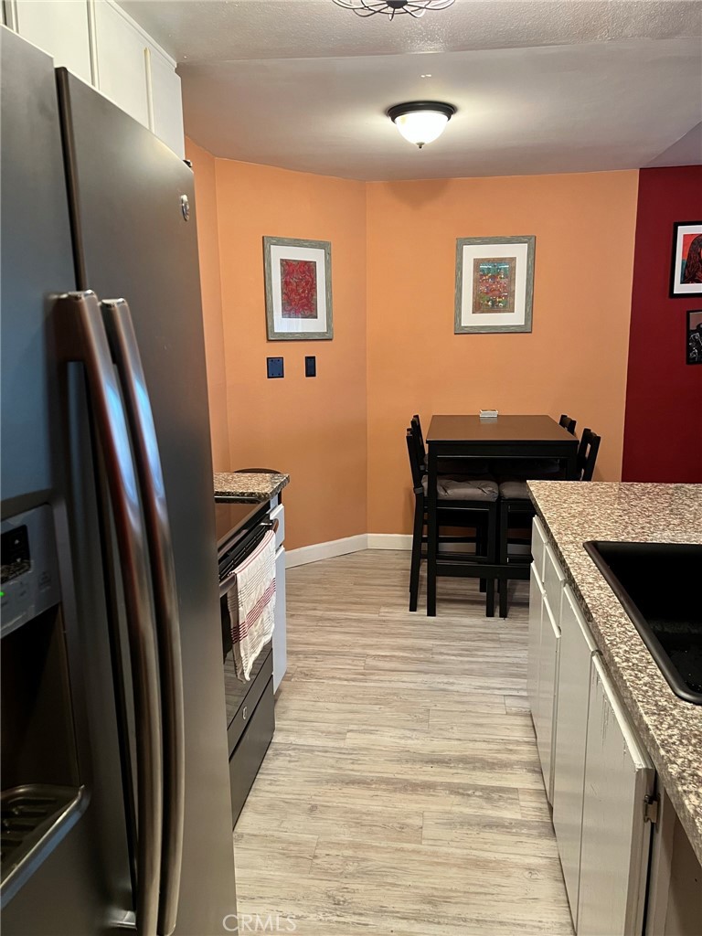1723 Cedar Avenue, Unit 102 Long Beach, CA 90813 - Photo 9 of 22 a kitchen with stainless steel appliances granite countertop a refrigerator and a stove