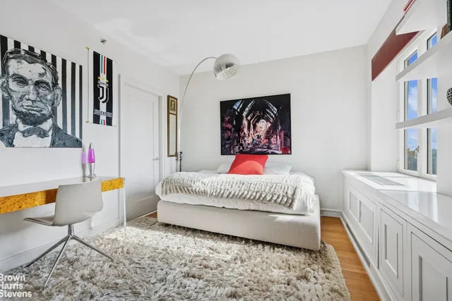 a bedroom with a bed and dresser