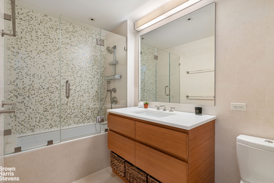 1280 5th Avenue, Unit 19C Manhattan, NY 10029 - Photo 9 of 20 a bathroom with a sink a toilet and shower