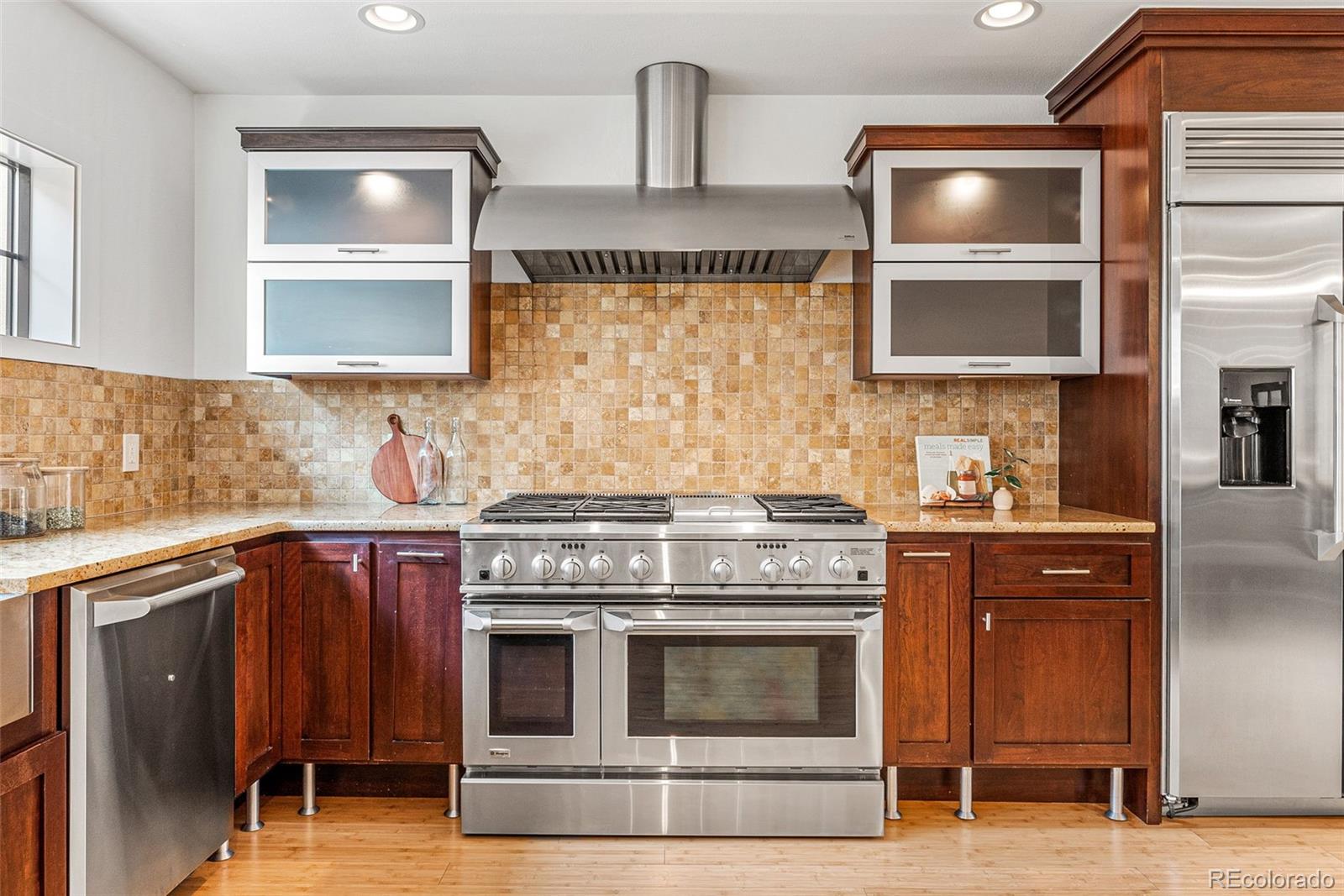 422 Cook Street Denver, CO 80206 - Photo 12 of 40 a kitchen with stainless steel appliances granite countertop a stove and a sink