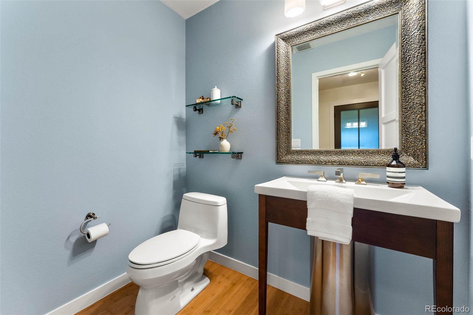 422 Cook Street Denver, CO 80206 - Photo 17 of 40 a bathroom with a toilet sink and mirror
