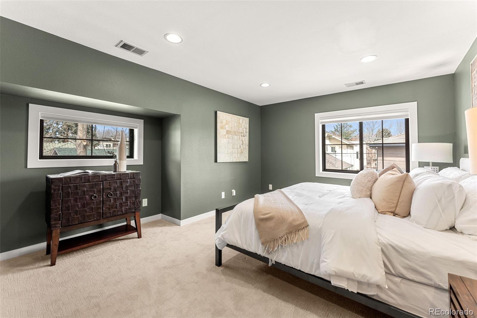 422 Cook Street Denver, CO 80206 - Photo 20 of 40 a bedroom with a large bed couch and window