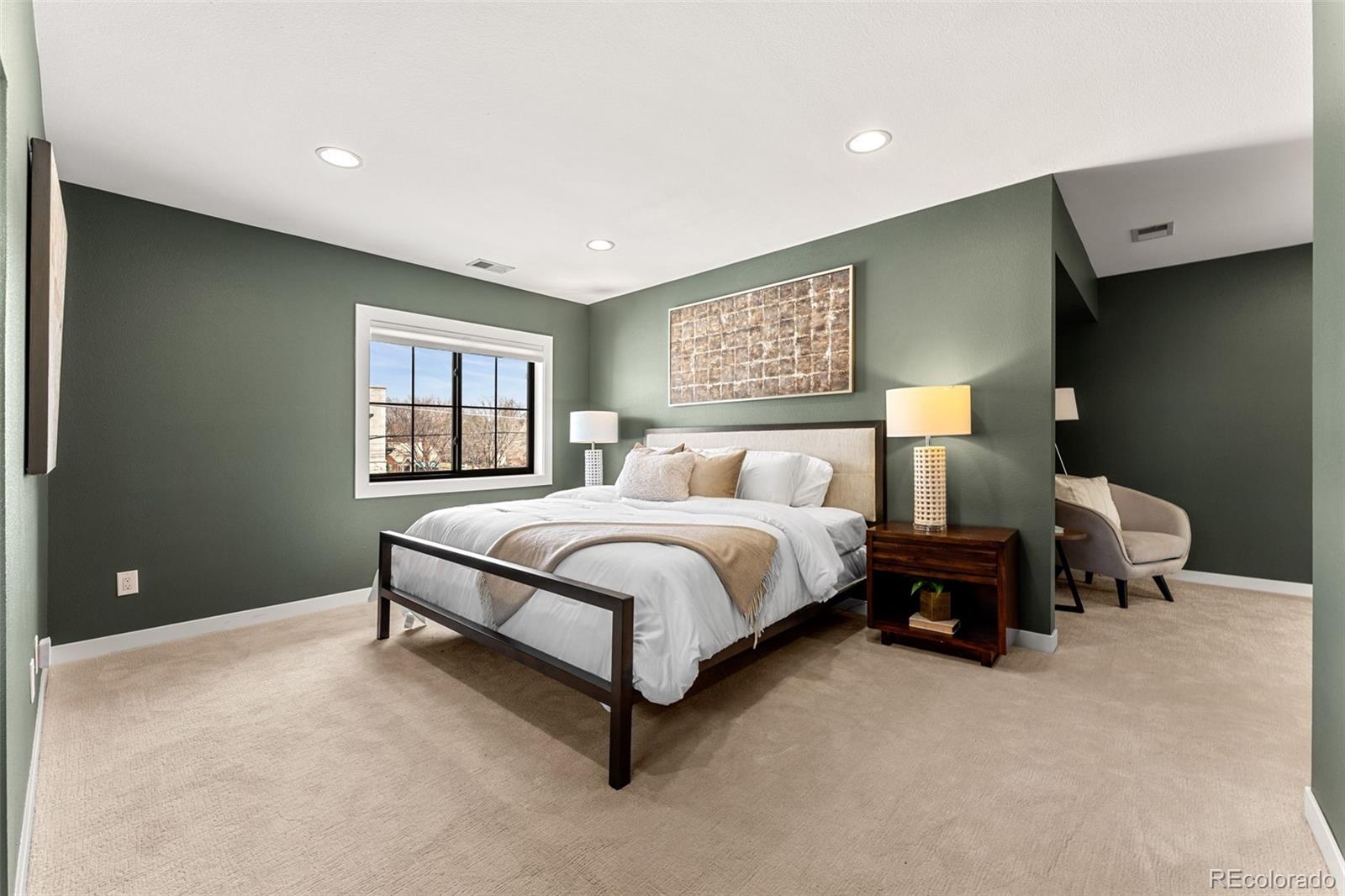 422 Cook Street Denver, CO 80206 - Photo 21 of 40 a spacious bedroom with a bed and window