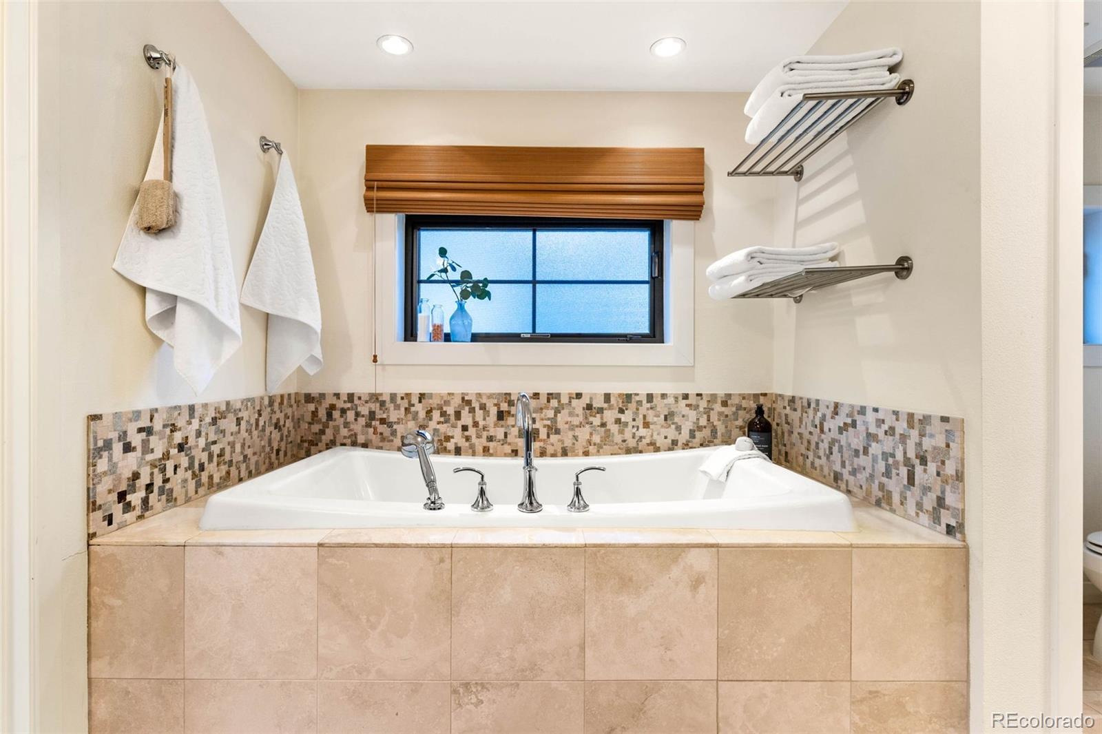 422 Cook Street Denver, CO 80206 - Photo 24 of 40 a bathroom with a bathtub and a shower