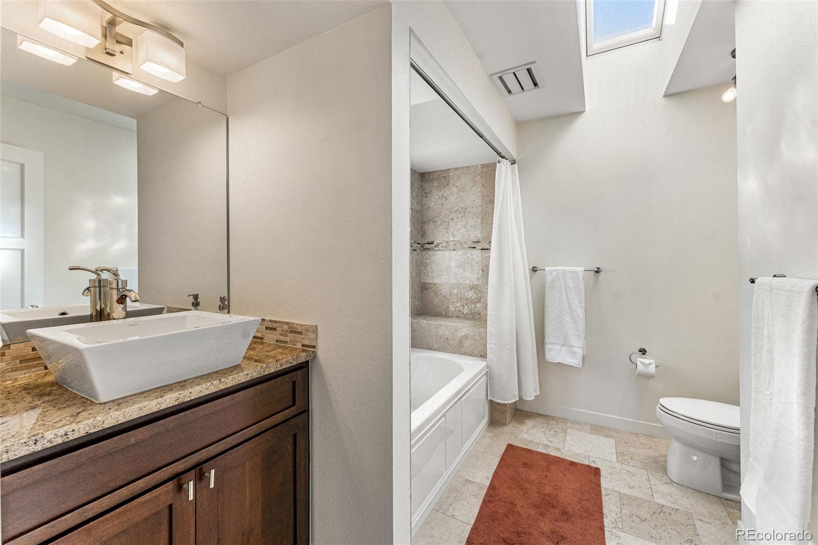 422 Cook Street Denver, CO 80206 - Photo 29 of 40 a bathroom with a sink a toilet and shower