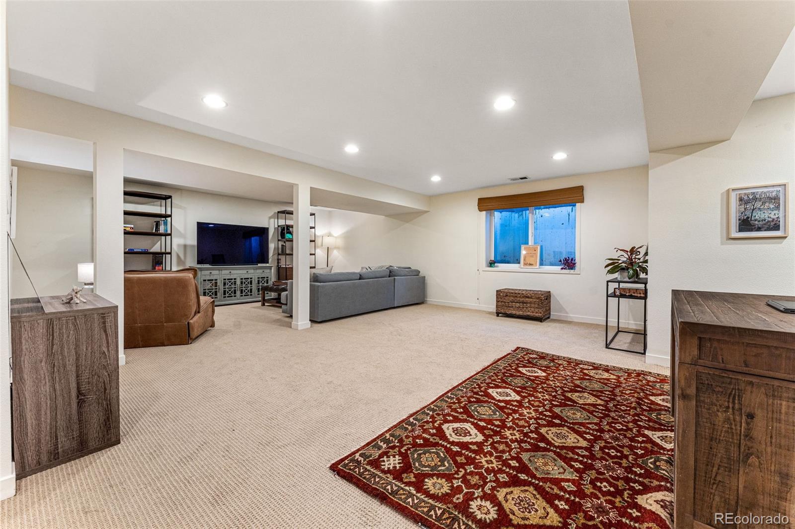 422 Cook Street Denver, CO 80206 - Photo 32 of 40 a living room with furniture and a rug