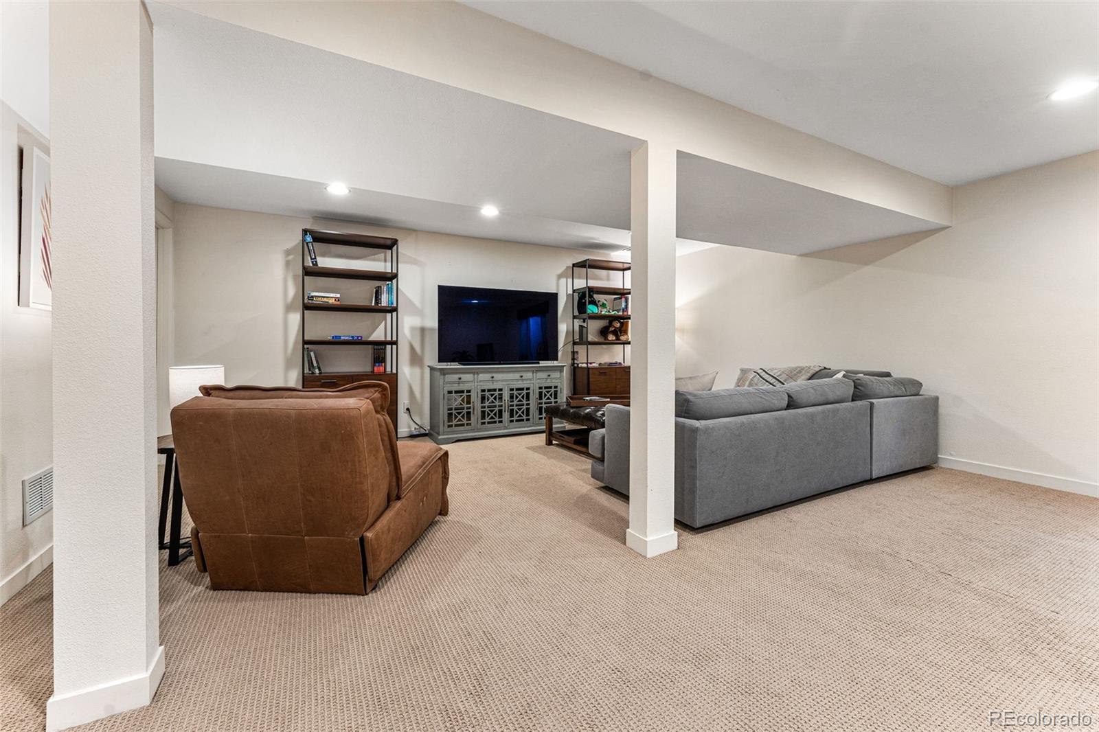 422 Cook Street Denver, CO 80206 - Photo 33 of 40 a living room with furniture and a flat screen tv