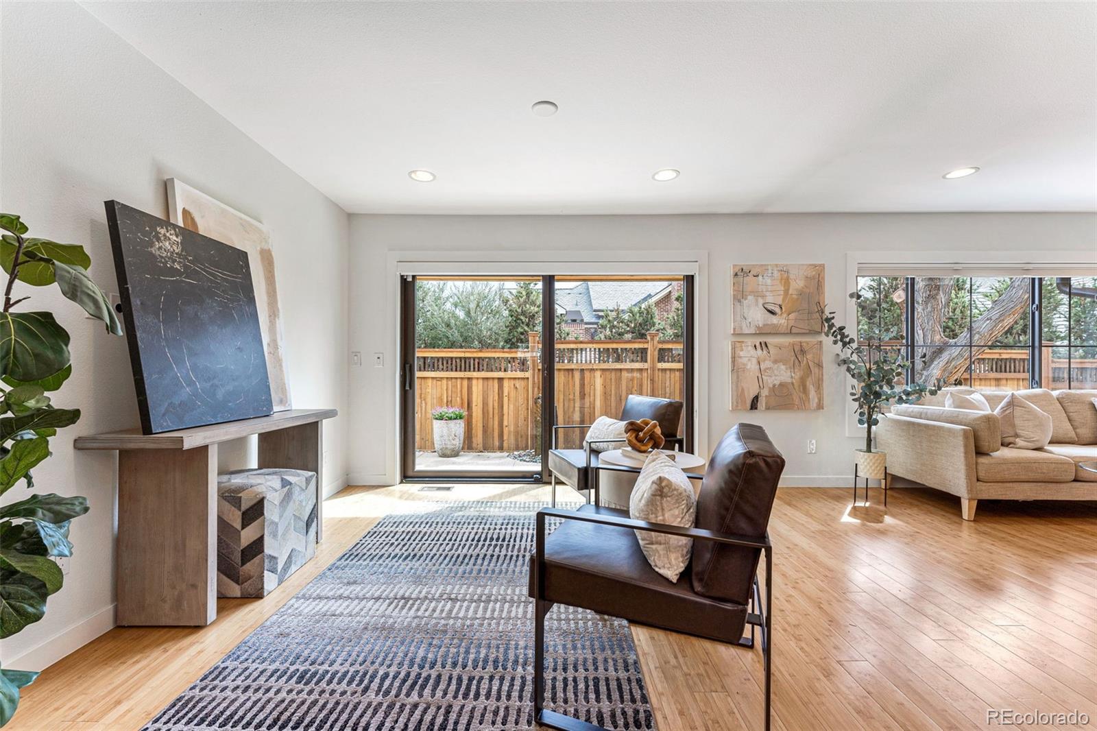 422 Cook Street Denver, CO 80206 - Photo 6 of 40 a living room with furniture a fireplace and a floor to ceiling window