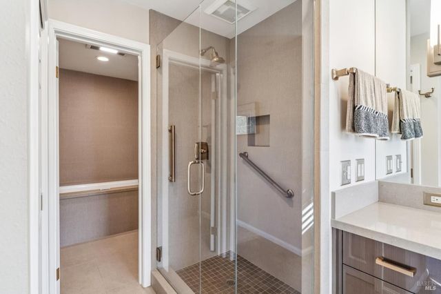 a bathroom with a shower and a sink