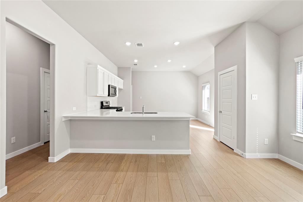 4005 High Valley McKinney, TX 75071 - Photo 5 of 18 a view of kitchen with wooden floor and electronic appliances