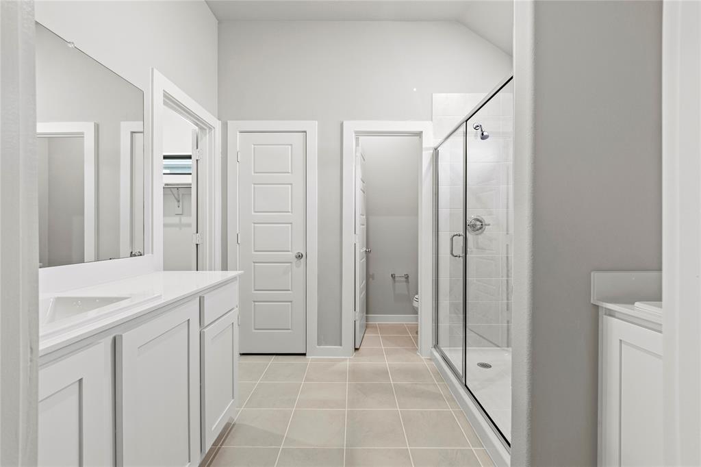 4005 High Valley McKinney, TX 75071 - Photo 9 of 18 a bathroom with a sink a mirror and a shower
