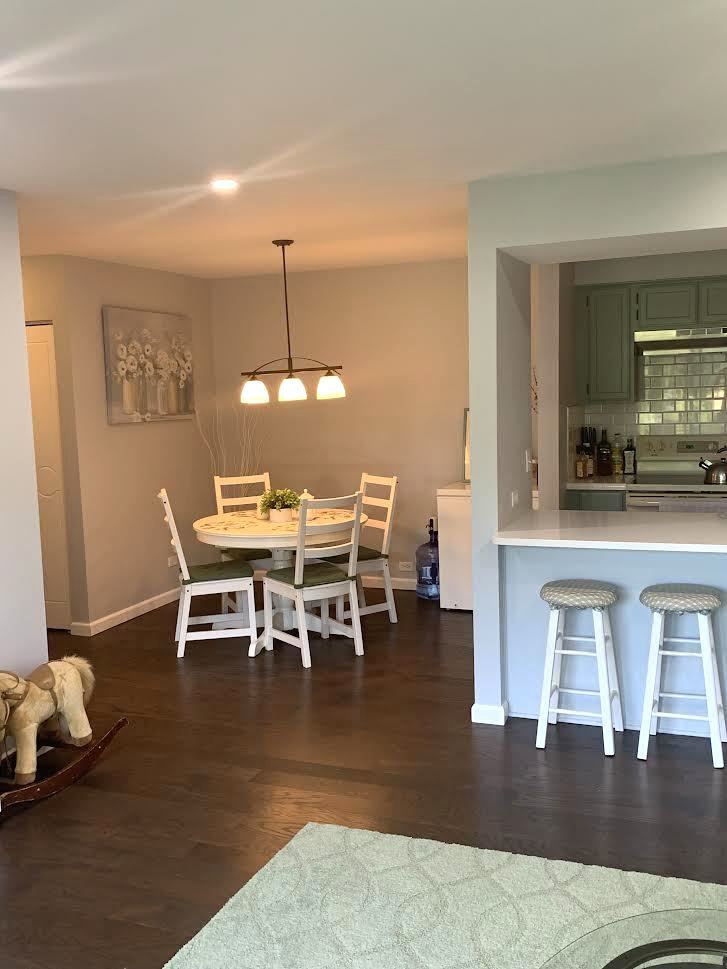 810 North River Road, Unit 3C Mount Prospect, IL 60056 - Photo 10 of 21 a dining room with furniture a chandelier and wooden floor