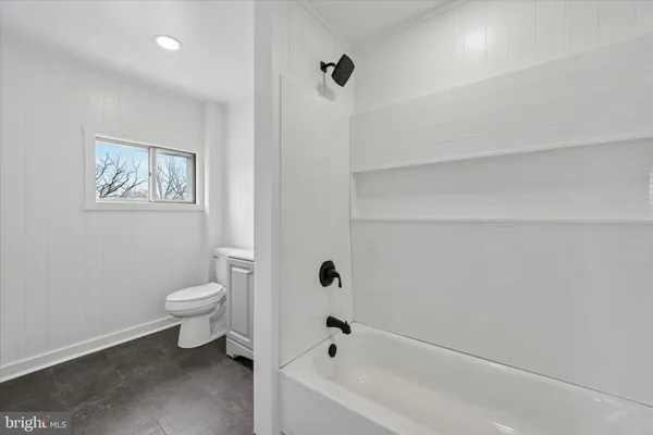 a bathroom with a toilet and a bathtub