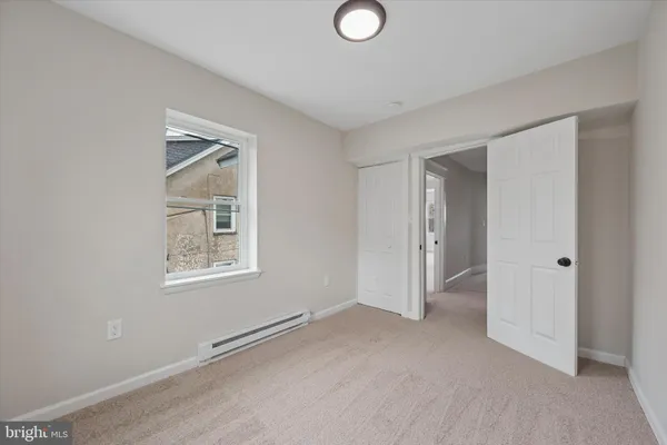 an empty room with windows and closet